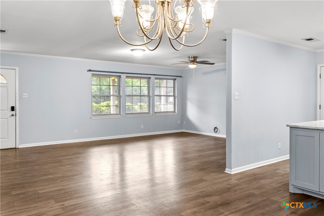 204 Berwick Road Victoria, TX 77904 - Photo 11 of 38 an empty room with wooden floor and windows
