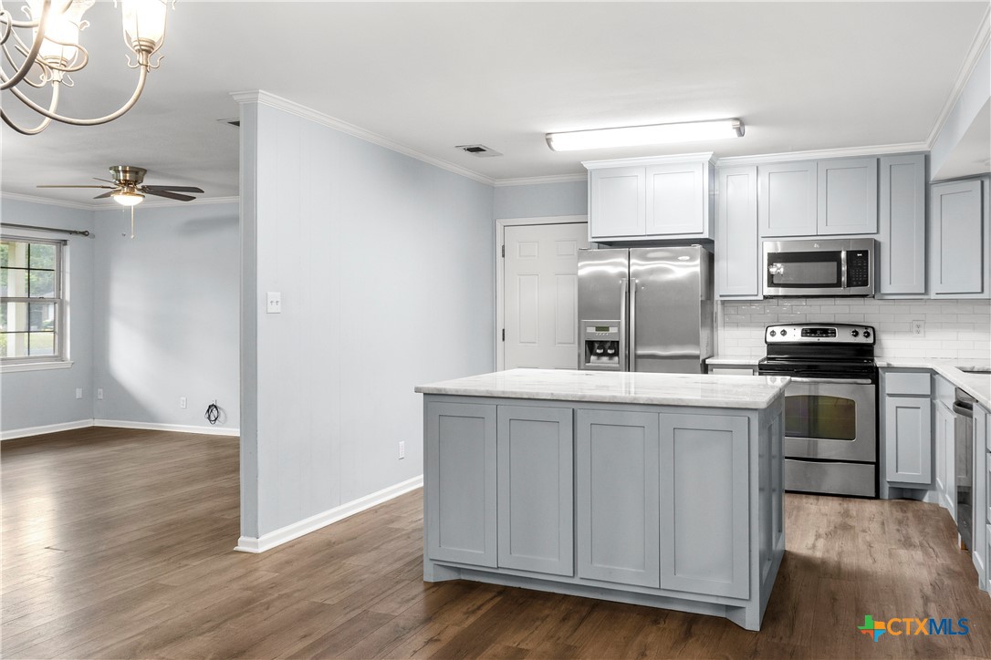 204 Berwick Road Victoria, TX 77904 - Photo 13 of 38 a kitchen with kitchen island granite countertop a sink cabinets and stainless steel appliances