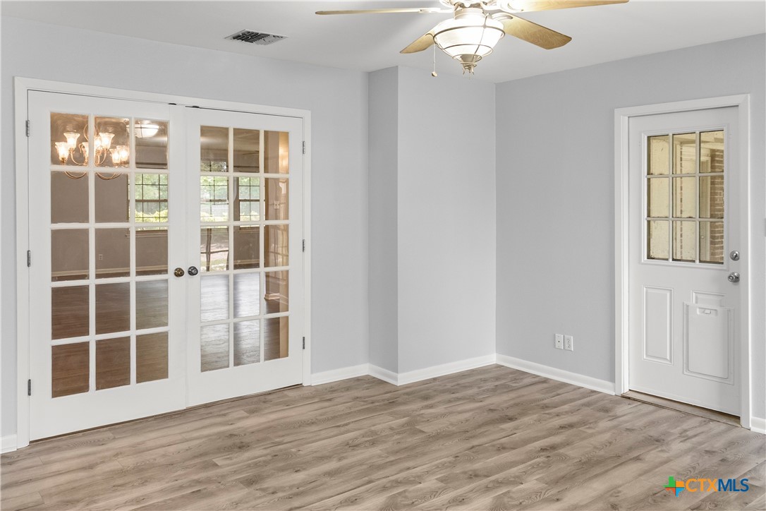 204 Berwick Road Victoria, TX 77904 - Photo 14 of 38 a view of an empty room with wooden floor and windows