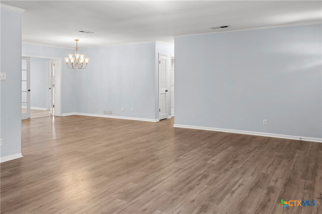 204 Berwick Road Victoria, TX 77904 - Photo 15 of 38 an empty room with wooden floor and windows