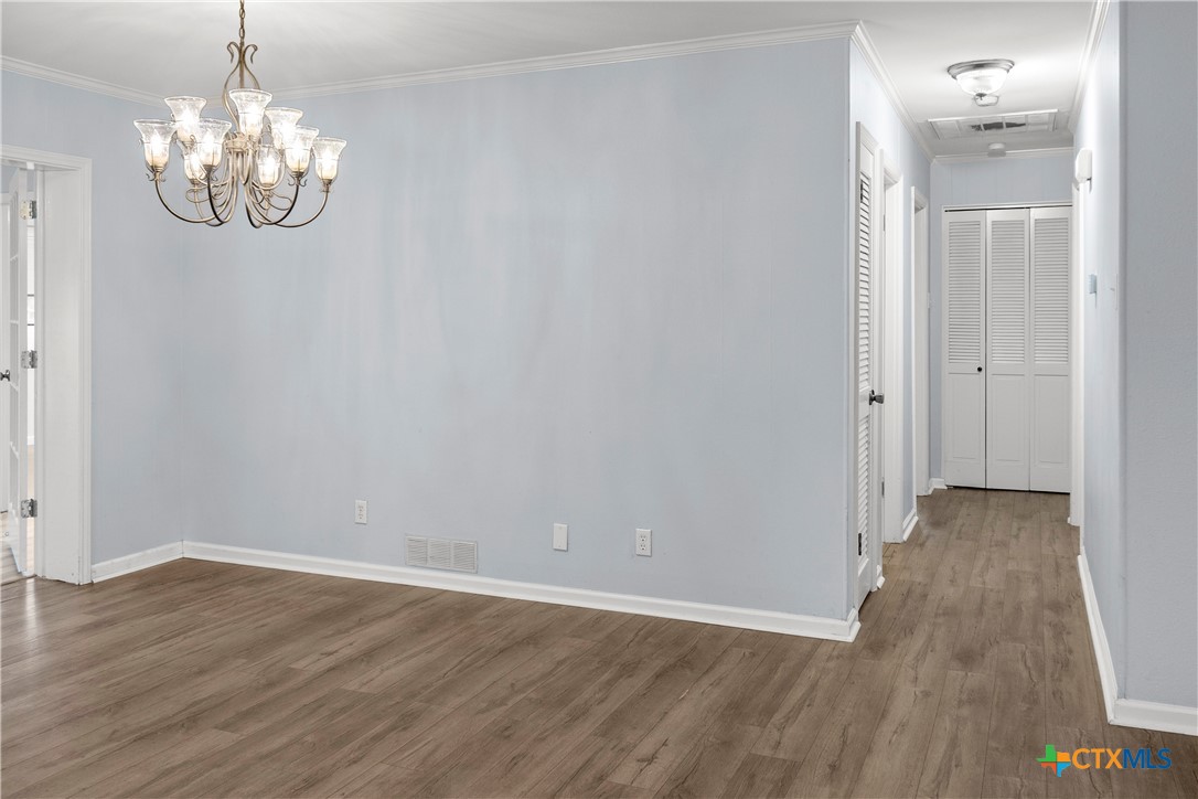 204 Berwick Road Victoria, TX 77904 - Photo 16 of 38 a view of an empty room with wooden floor