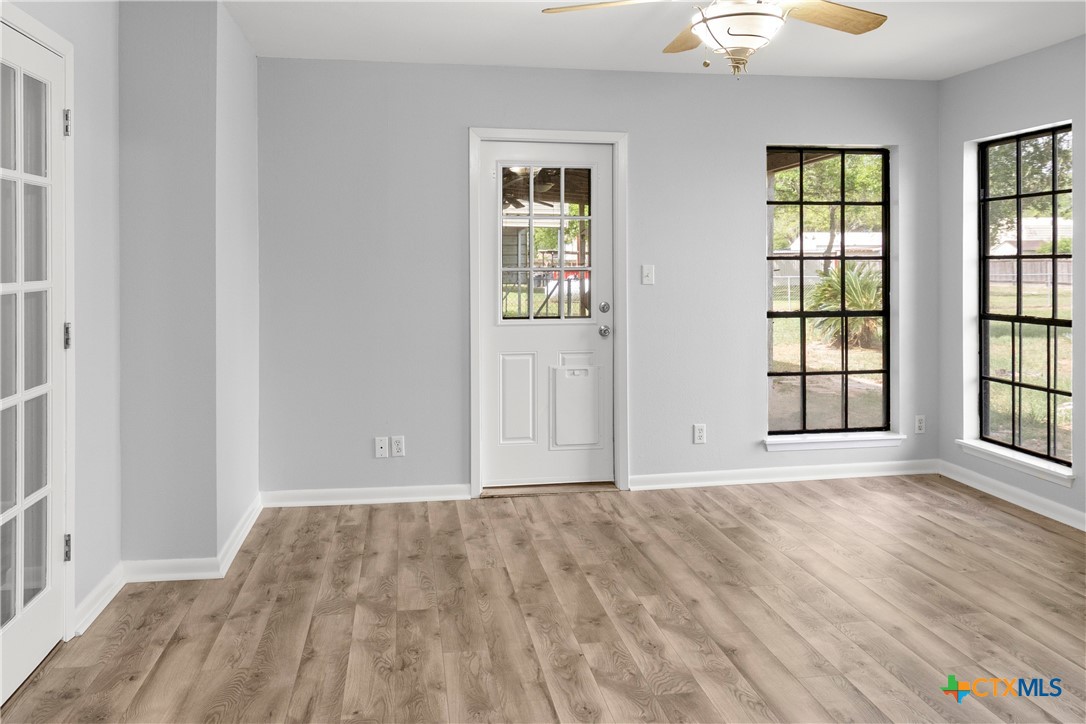 204 Berwick Road Victoria, TX 77904 - Photo 17 of 38 a view of an empty room with wooden floor and a window