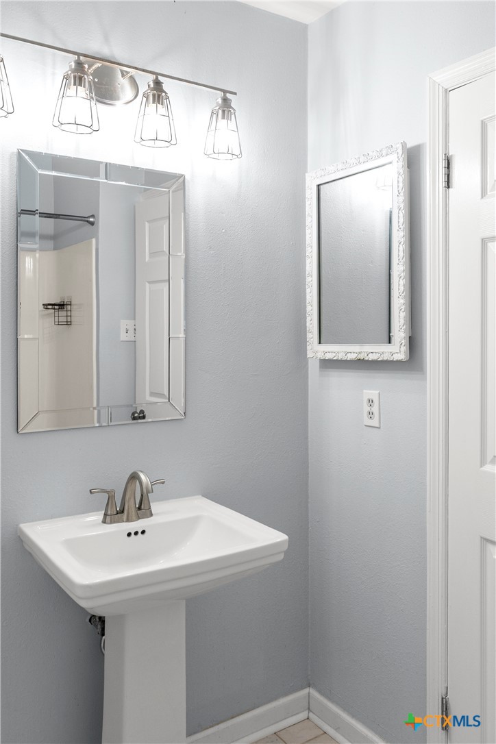 204 Berwick Road Victoria, TX 77904 - Photo 19 of 38 a bathroom with a sink and a mirror