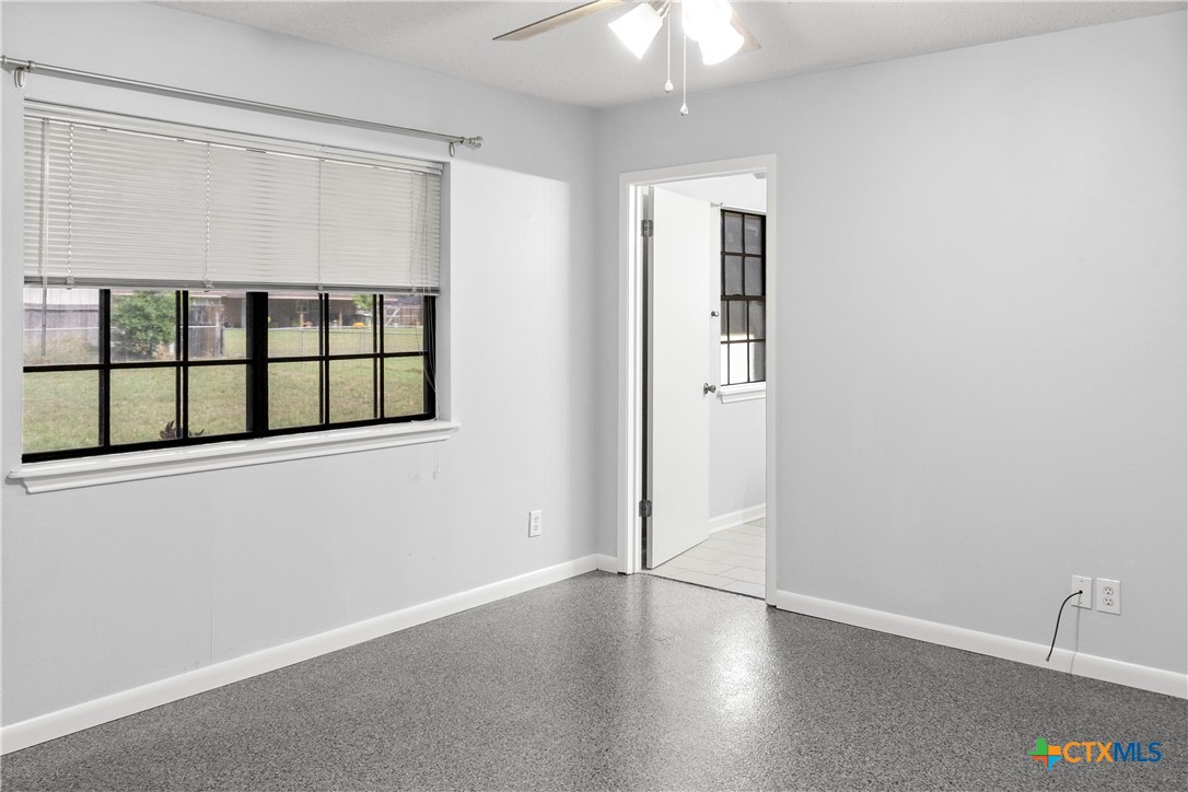 204 Berwick Road Victoria, TX 77904 - Photo 22 of 38 an empty room with wooden floor cabinet and windows