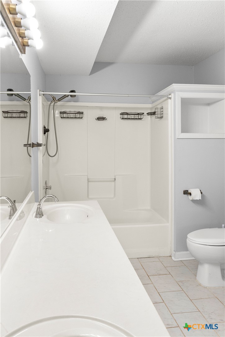 204 Berwick Road Victoria, TX 77904 - Photo 26 of 38 a bathroom with a sink a toilet and shower