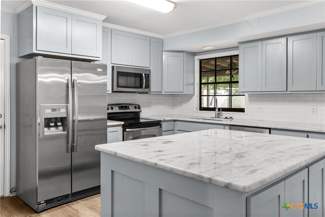 204 Berwick Road Victoria, TX 77904 - Photo 6 of 38 a kitchen with stainless steel appliances granite countertop a refrigerator a stove and a sink