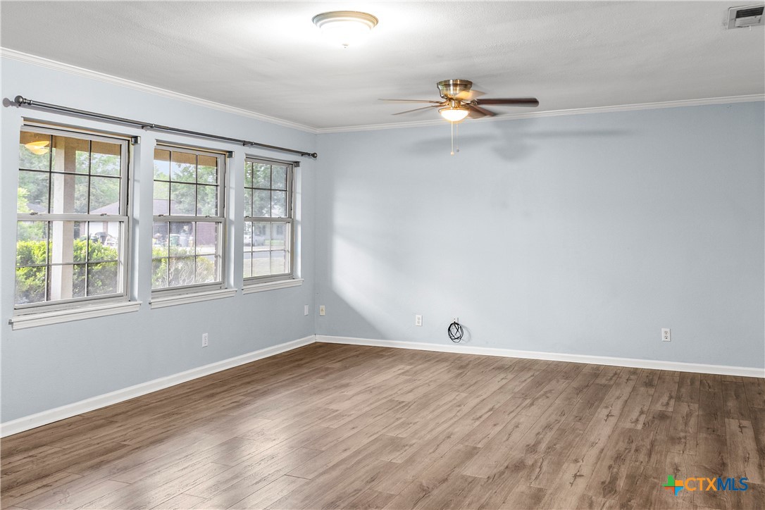 204 Berwick Road Victoria, TX 77904 - Photo 7 of 38 wooden floor in an empty room with a window