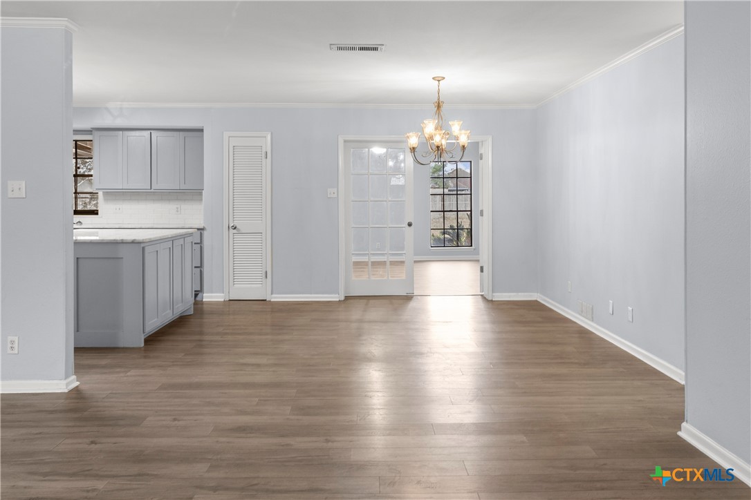 204 Berwick Road Victoria, TX 77904 - Photo 9 of 38 wooden floor in an empty room with a window