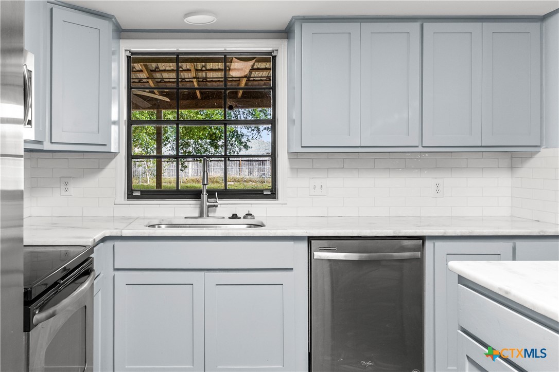 204 Berwick Road Victoria, TX 77904 - Photo 10 of 38 a kitchen with a sink stove and cabinets