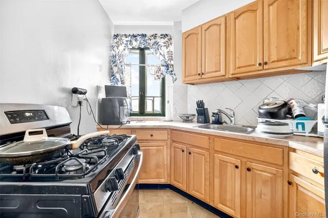 a kitchen with stainless steel appliances granite countertop a stove and a sink