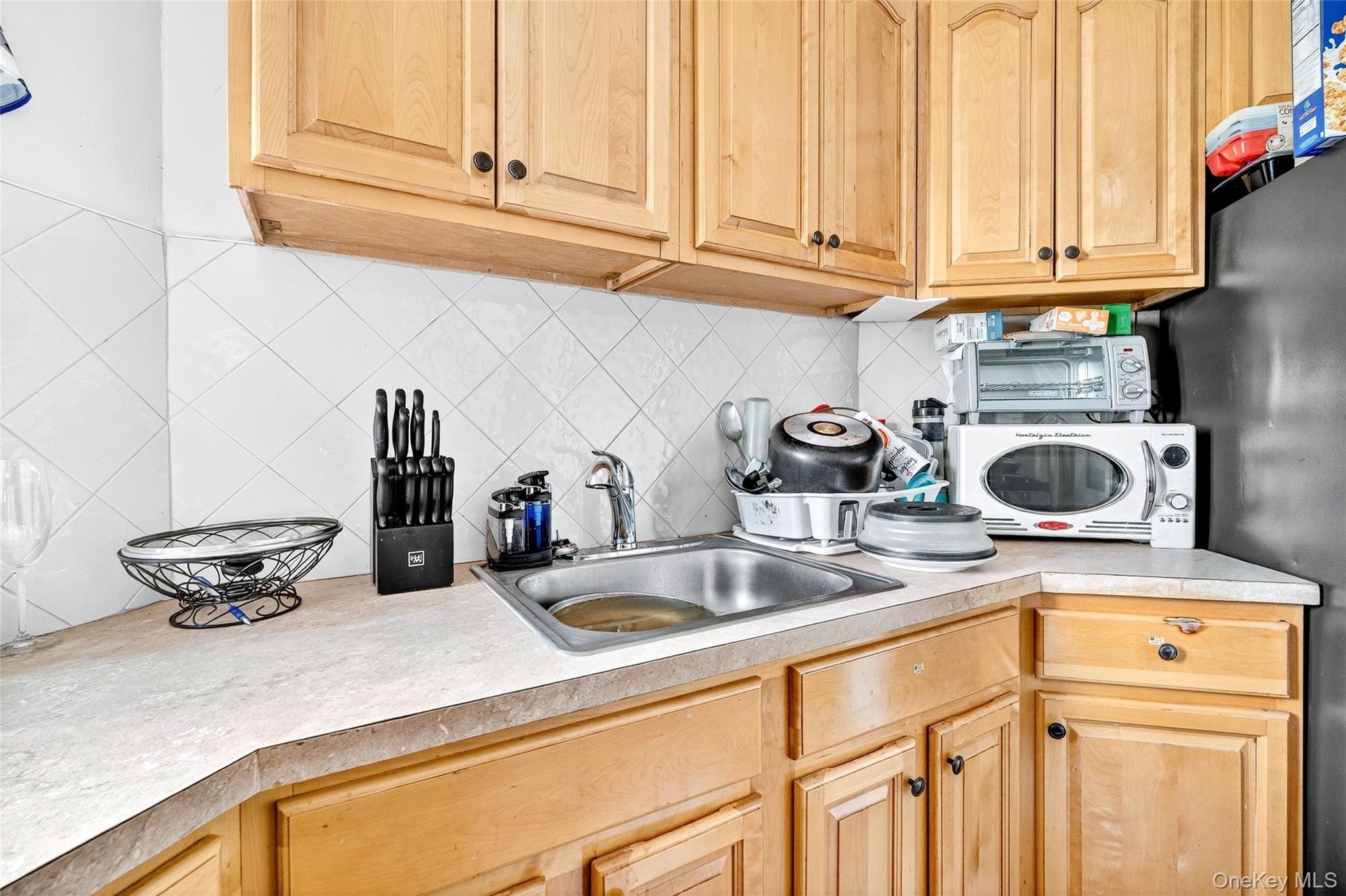 1314 Virginia Avenue, Unit 6G Bronx, NY 10462 - Photo 12 of 34 a kitchen with a sink and cabinets