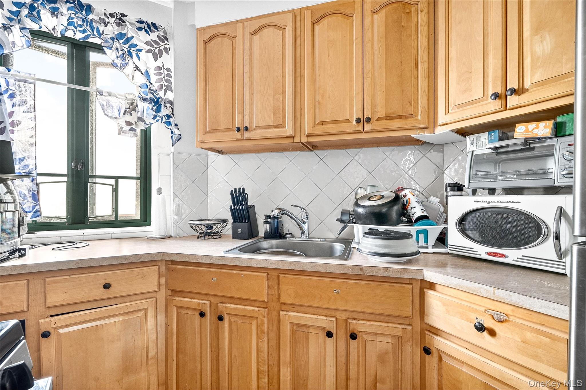 1314 Virginia Avenue, Unit 6G Bronx, NY 10462 - Photo 13 of 34 a kitchen with stainless steel appliances granite countertop a sink a stove and cabinets