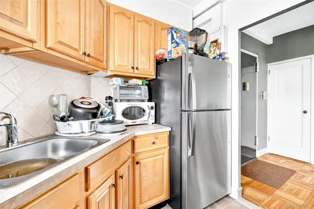 a kitchen with stainless steel appliances granite countertop a refrigerator and a sink