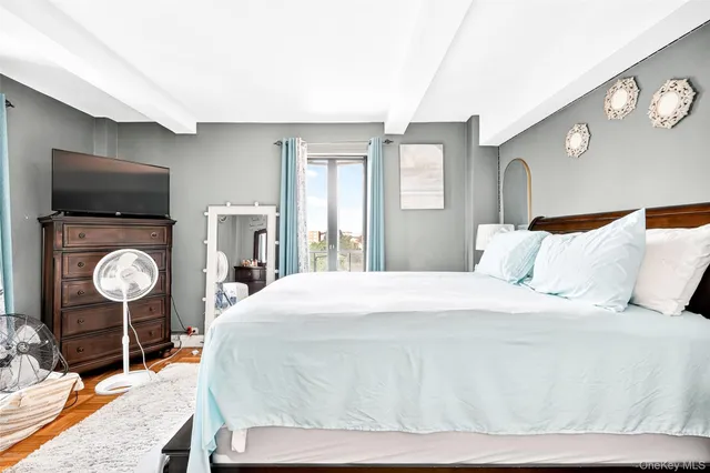 a bedroom with a bed and a mirror