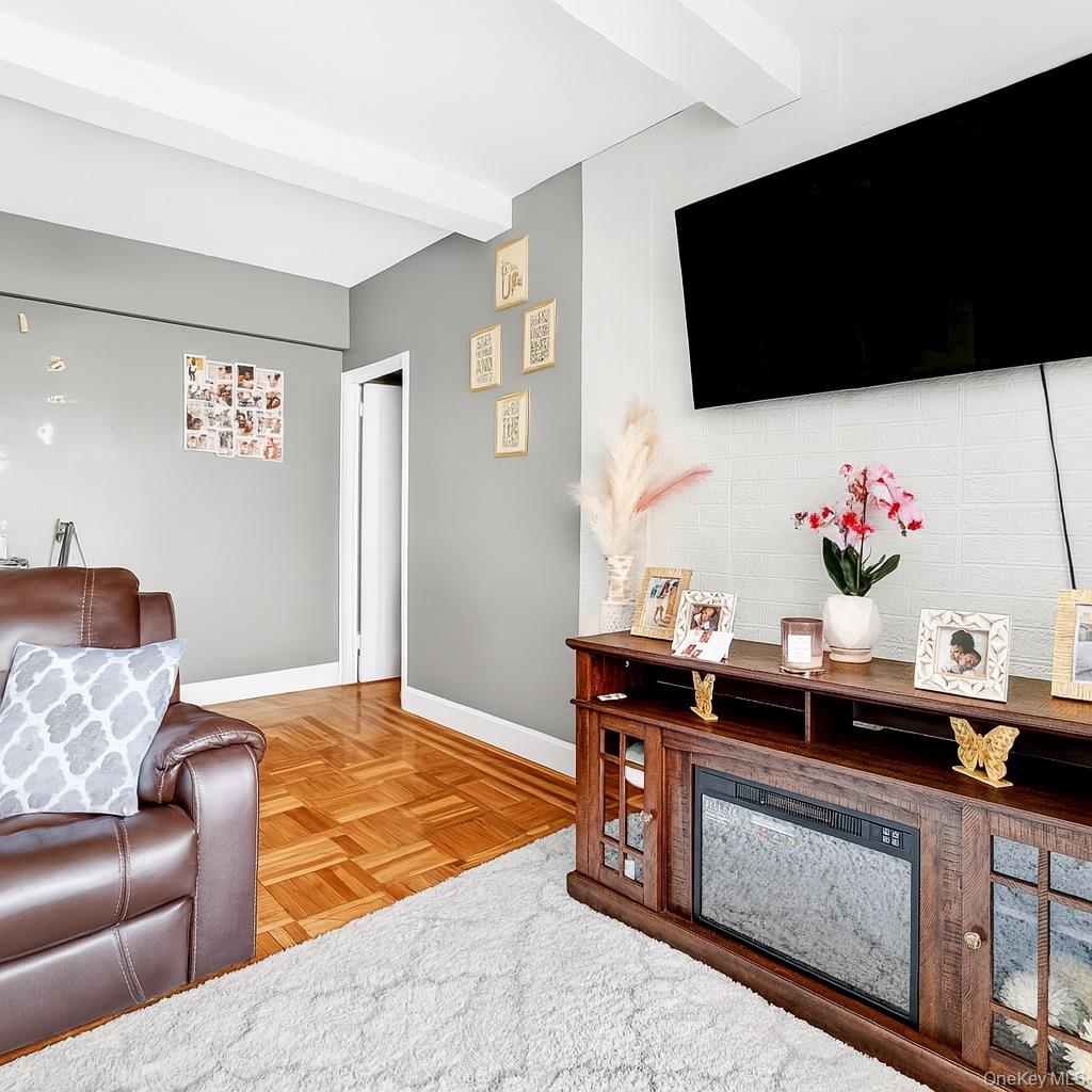 1314 Virginia Avenue, Unit 6G Bronx, NY 10462 - Photo 21 of 34 a living room with furniture and a flat screen tv