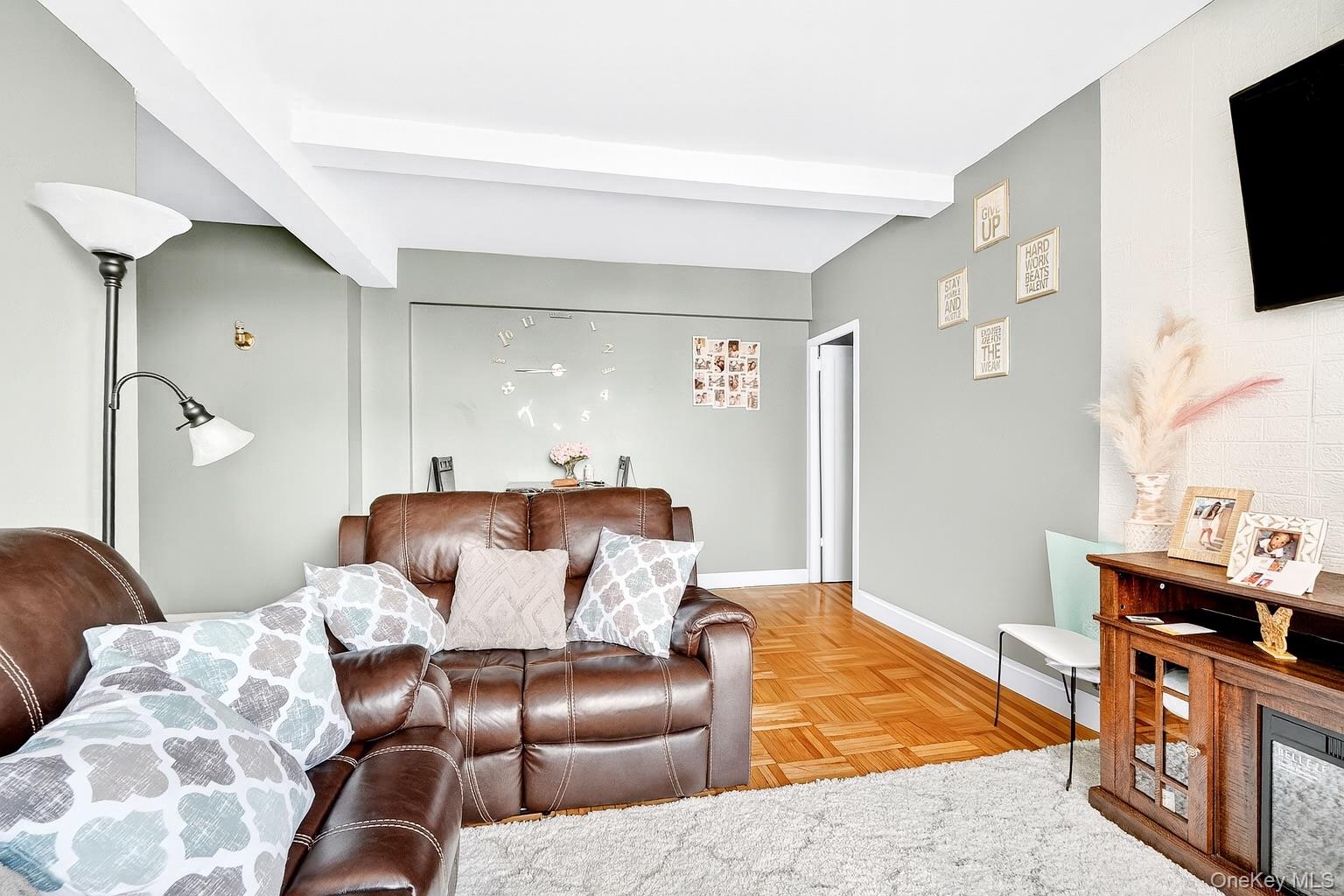 1314 Virginia Avenue, Unit 6G Bronx, NY 10462 - Photo 22 of 34 a living room with furniture and a flat screen tv