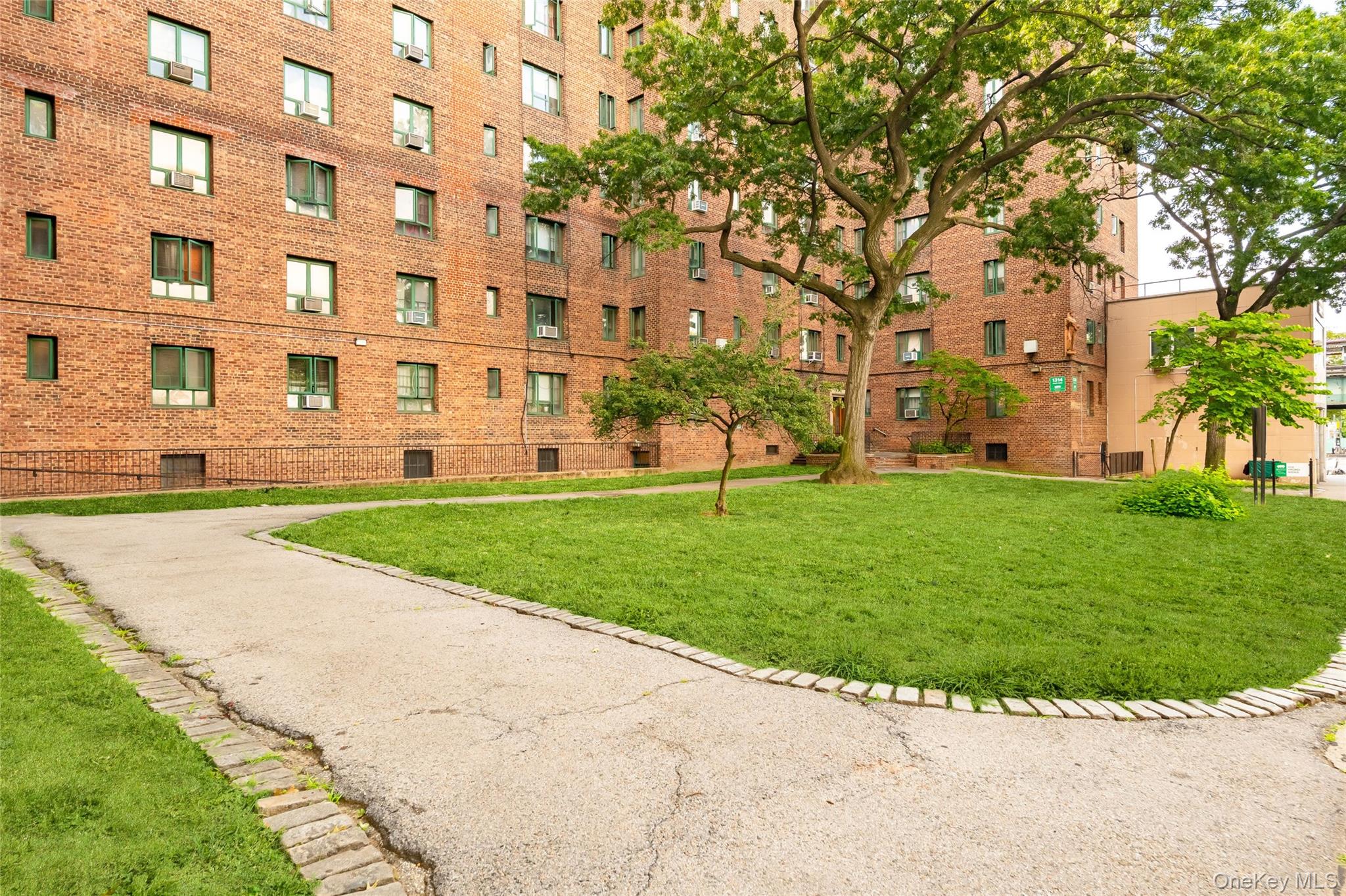 1314 Virginia Avenue, Unit 6G Bronx, NY 10462 - Photo 26 of 34 a view of a building with a yard