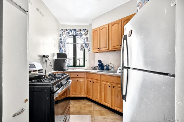 a kitchen with stainless steel appliances granite countertop a refrigerator sink and cabinets