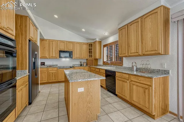 a kitchen with counter top space cabinets and appliances