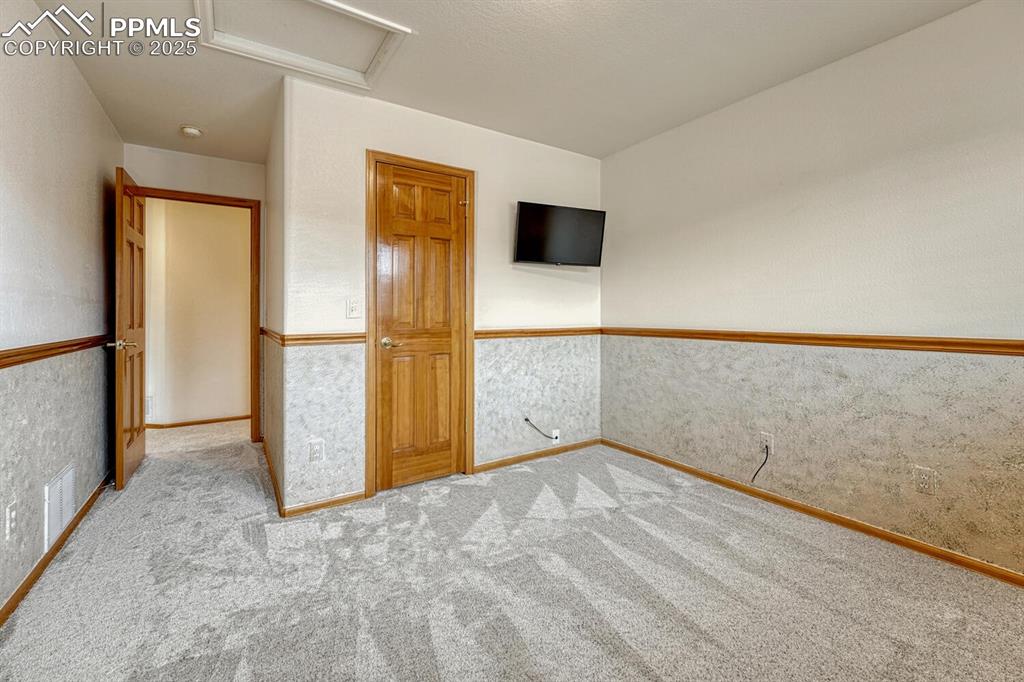 339 Sandreed Place Colorado Springs, CO 80921 - Photo 32 of 50 Unfurnished bedroom featuring attic access and carpet flooring