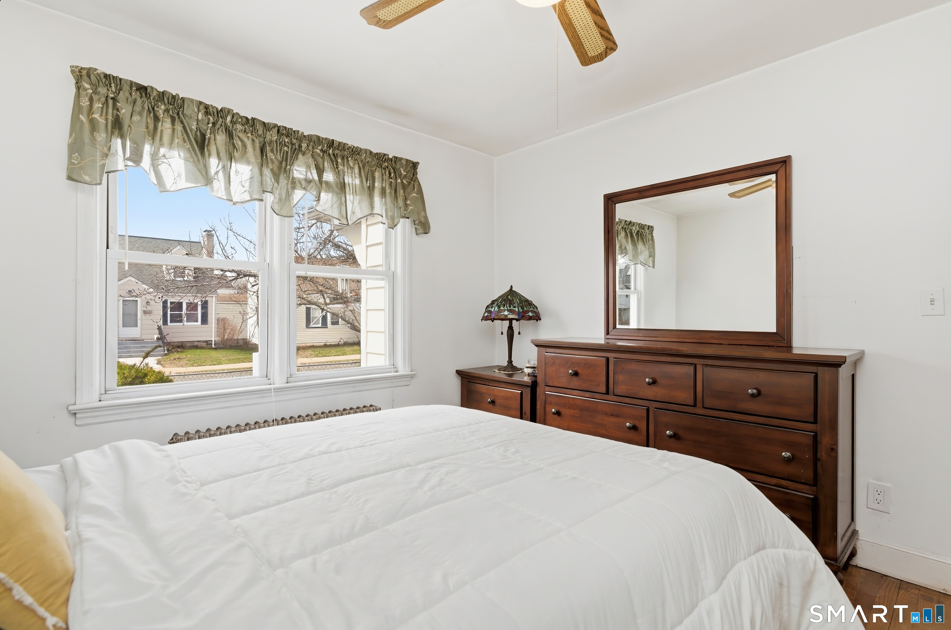 170 Hillside Avenue Bridgeport, CT 06604 - Photo 16 of 35 a bedroom with a bed and a flat tv screen on dresser