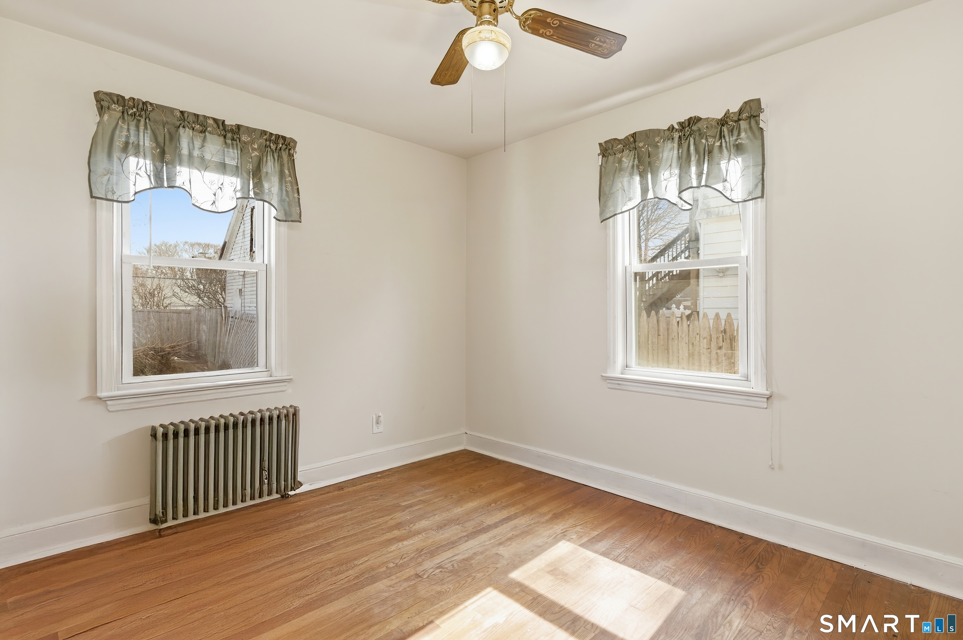 170 Hillside Avenue Bridgeport, CT 06604 - Photo 18 of 35 an empty room with wooden floor chandelier and windows