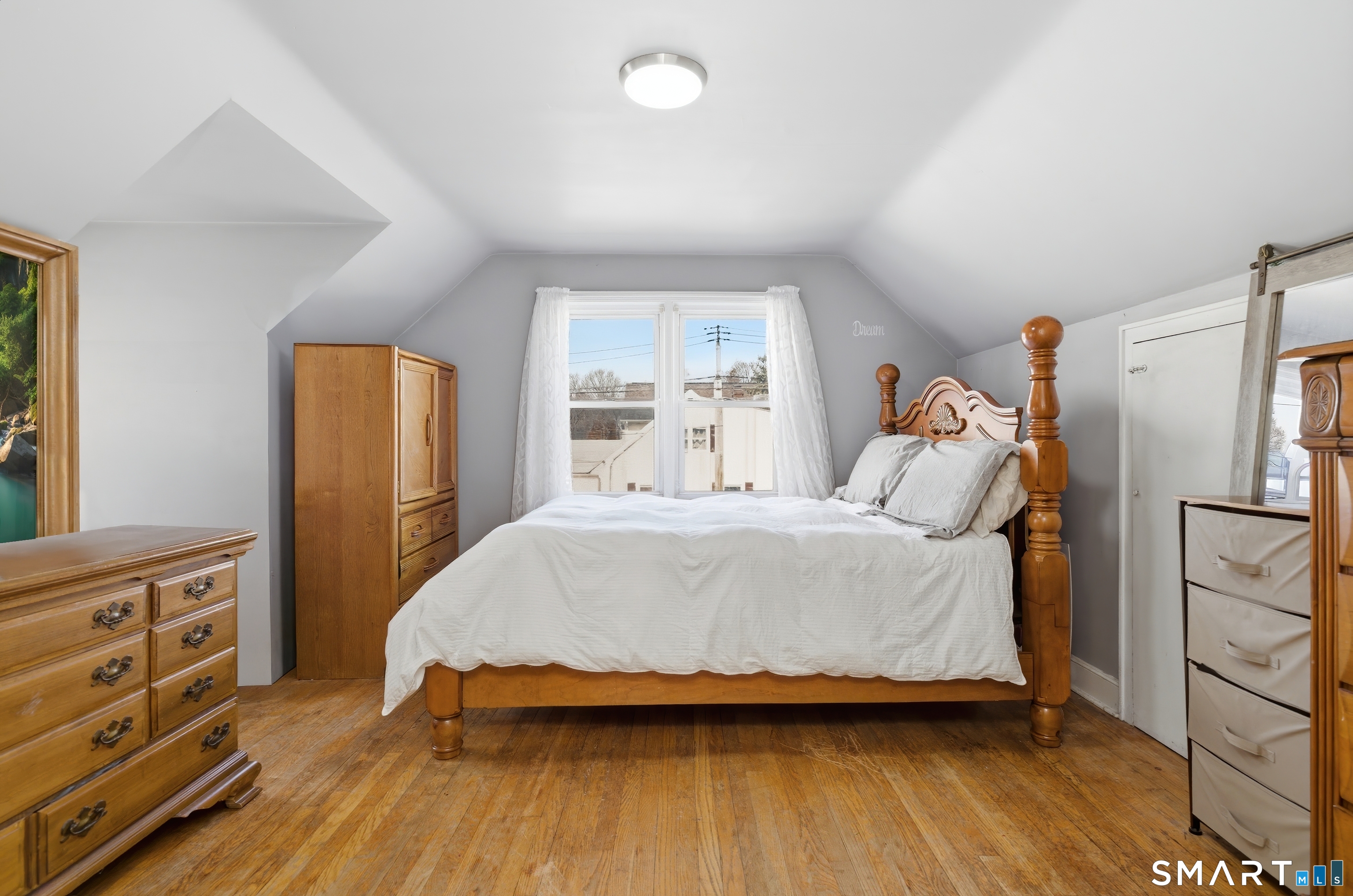 170 Hillside Avenue Bridgeport, CT 06604 - Photo 25 of 35 a bedroom with a bed and wooden floor