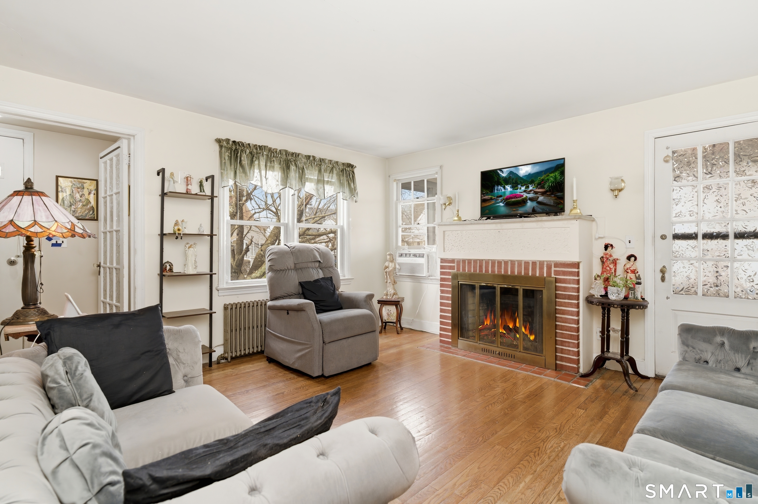 170 Hillside Avenue Bridgeport, CT 06604 - Photo 3 of 35 a living room with furniture and a fireplace
