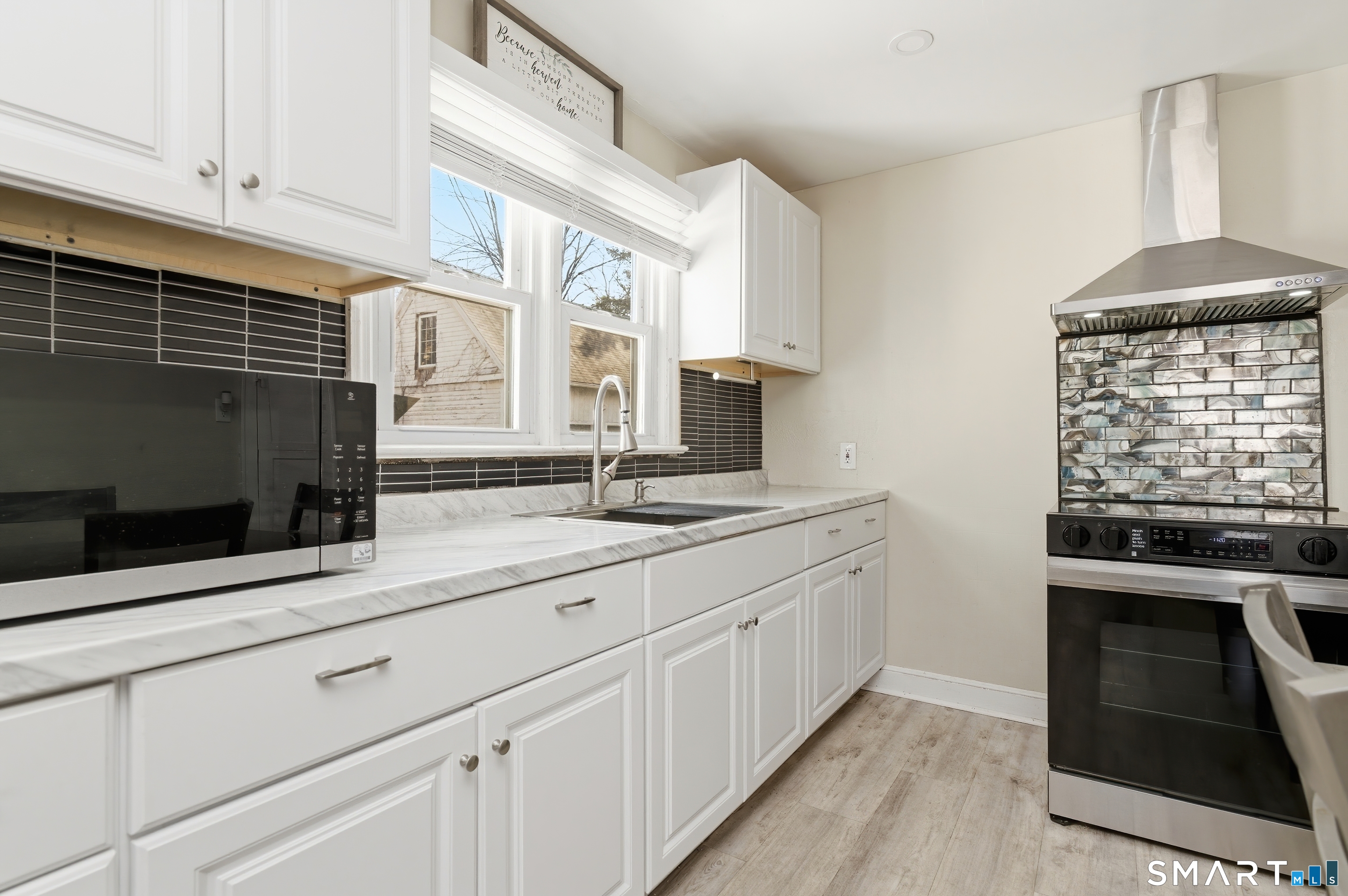 170 Hillside Avenue Bridgeport, CT 06604 - Photo 7 of 35 a kitchen with stainless steel appliances a stove and a sink