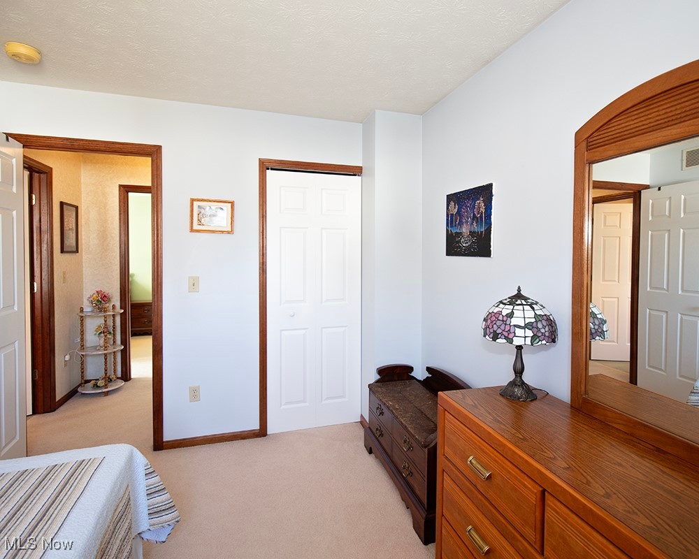 1614 South Abbe Road Elyria, OH 44035 - Photo 18 of 35 Bedroom with visible vents, baseboards, arched walkways, a textured ceiling, and light colored carpet