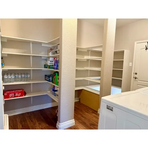 a kitchen with kitchen island a refrigerator and a sink