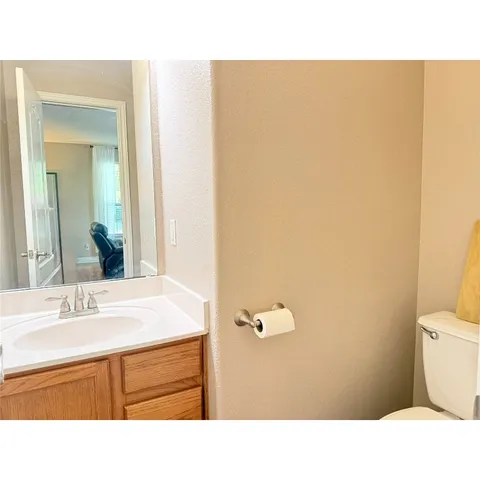 a living room with a bed furniture chandelier and a window