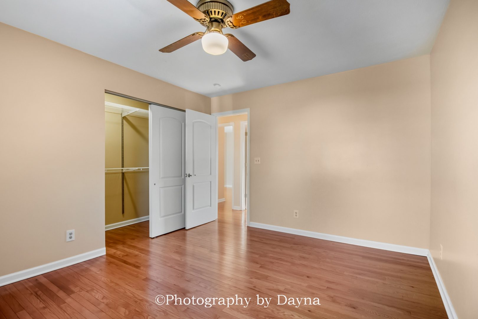 711 Sycamore Street Watseka, IL 60970 - Photo 12 of 21 an empty room with wooden floor closet and ceiling fan