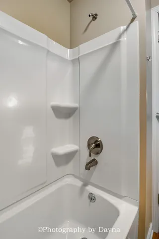 a bathroom with a tub and a shower