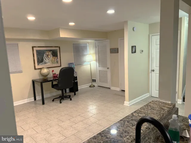 a view of a livingroom with wooden floor and stairs