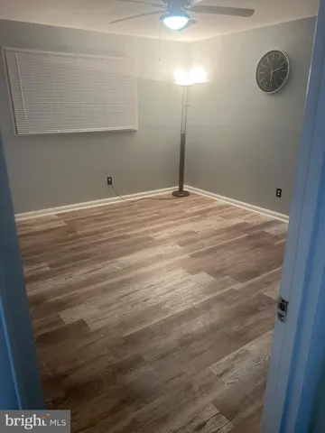 a bedroom with a bed and a ceiling fan
