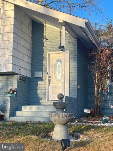 a front view of a house with a fountain