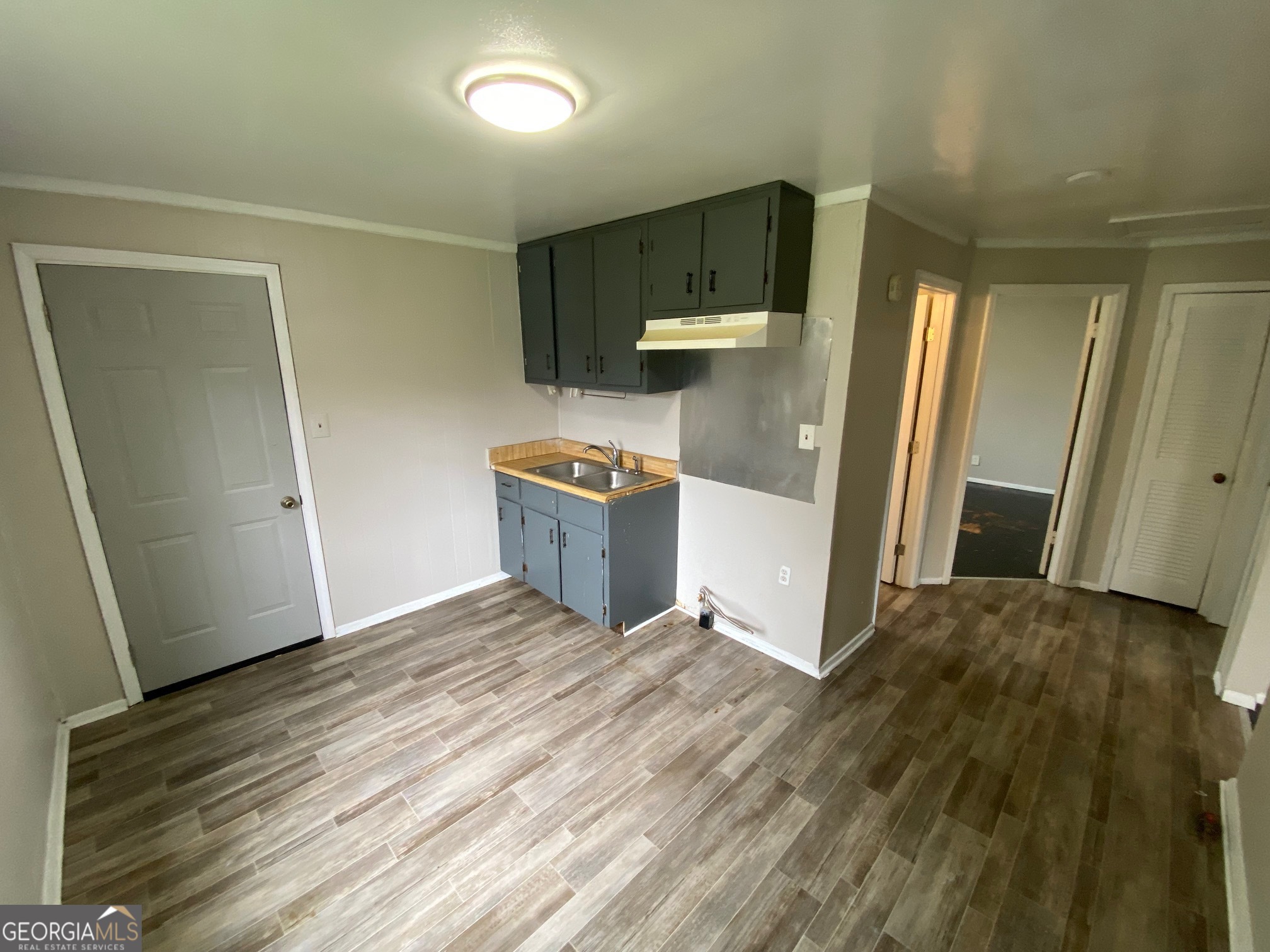912 Thomas Street Macon, GA 31206 - Photo 4 of 23 a view of kitchen with refrigerator and wooden floor