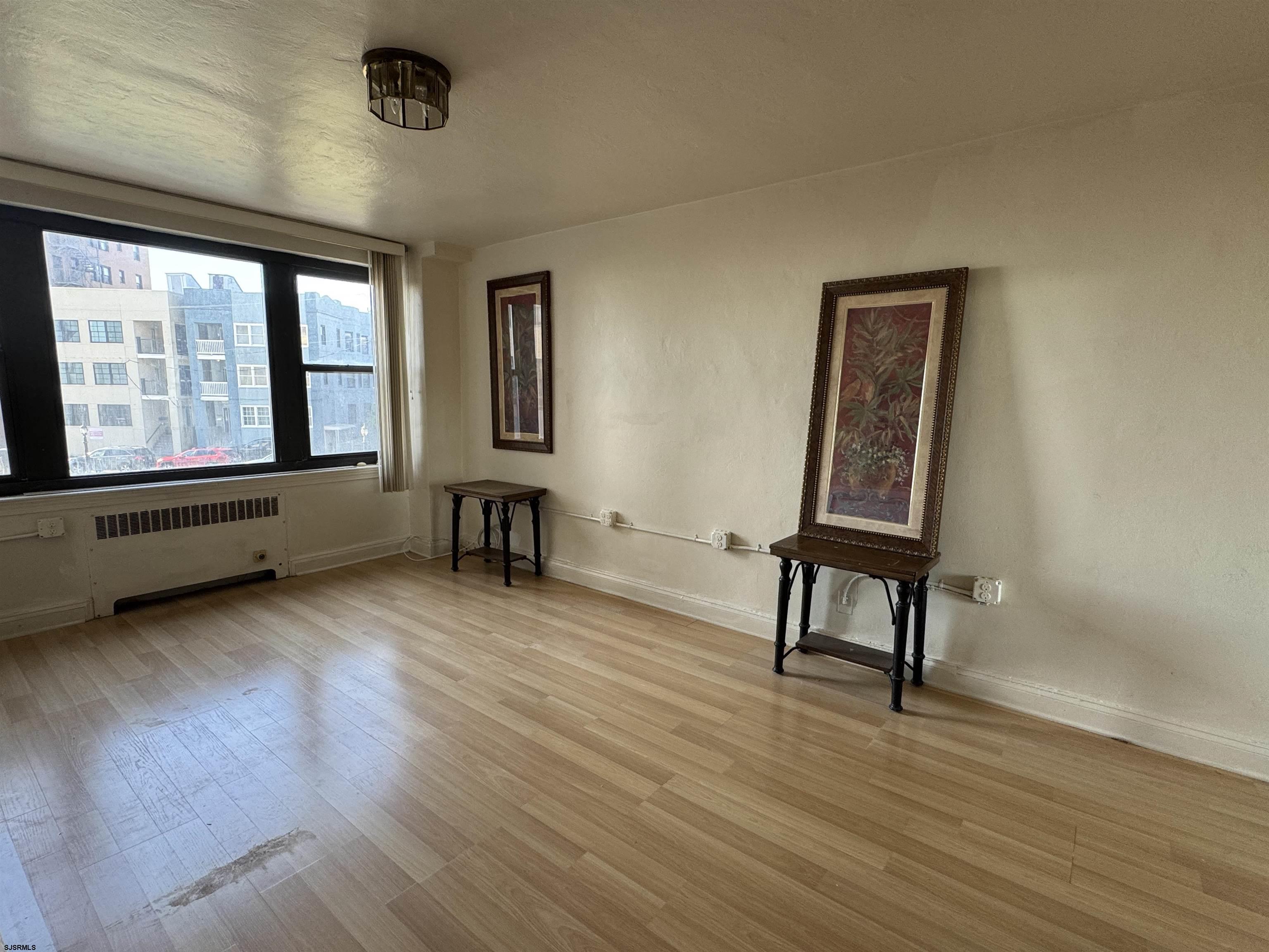 101 South Raleigh Avenue, Unit 210 Atlantic City, NJ 08401 - Photo 12 of 24 a view of an empty room with glass door and furniture