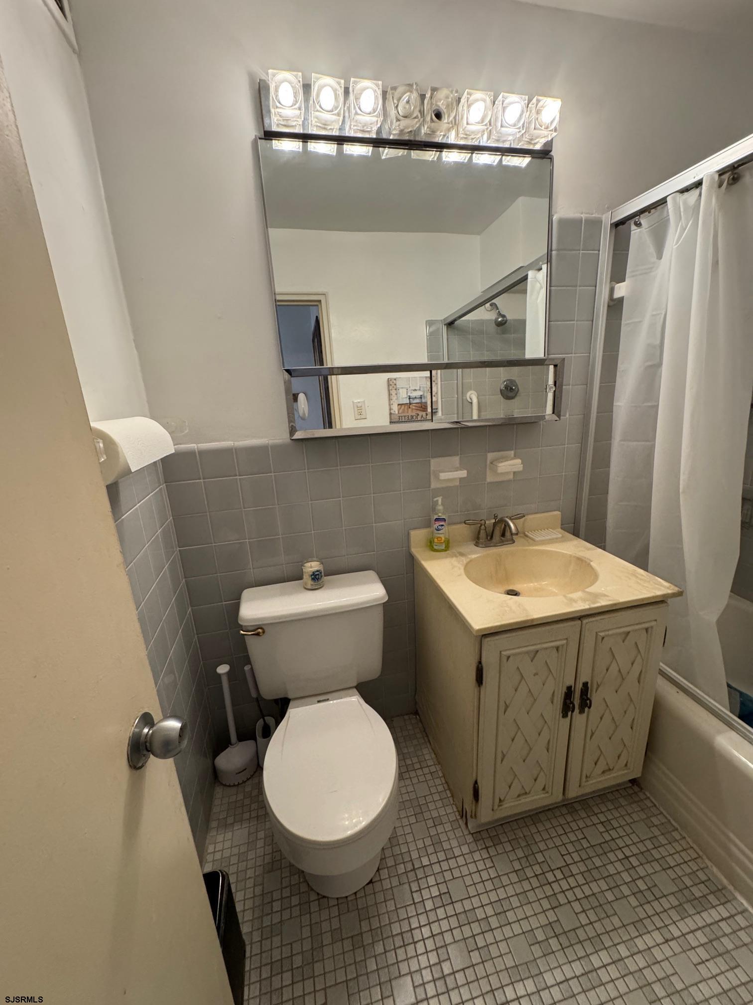 101 South Raleigh Avenue, Unit 210 Atlantic City, NJ 08401 - Photo 13 of 24 a bathroom with a sink and mirror