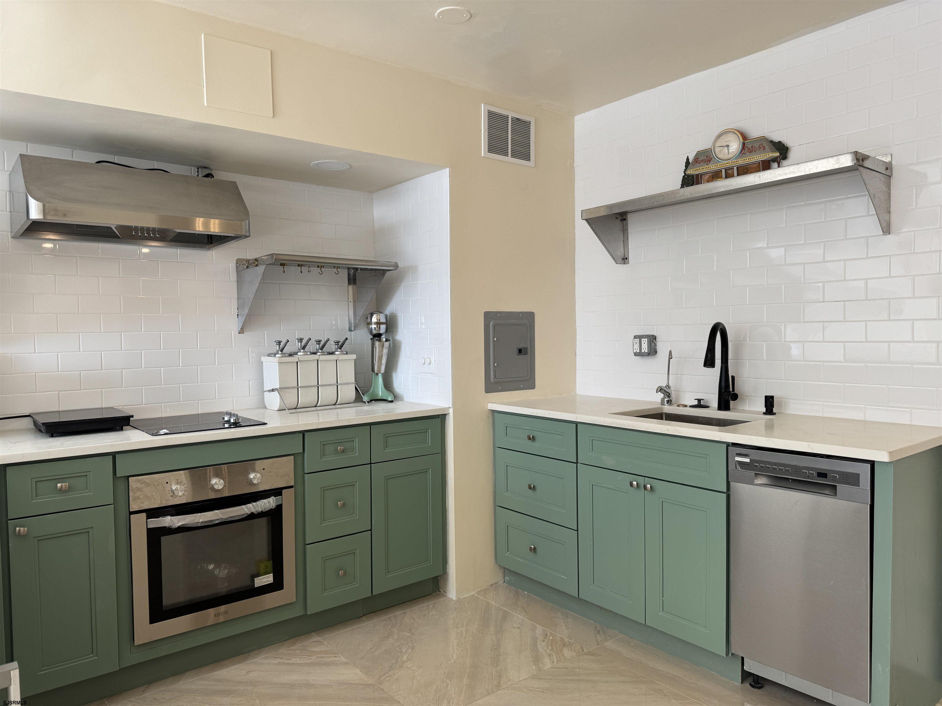 101 South Raleigh Avenue, Unit 210 Atlantic City, NJ 08401 - Photo 2 of 24 a kitchen with stainless steel appliances a sink and cabinets