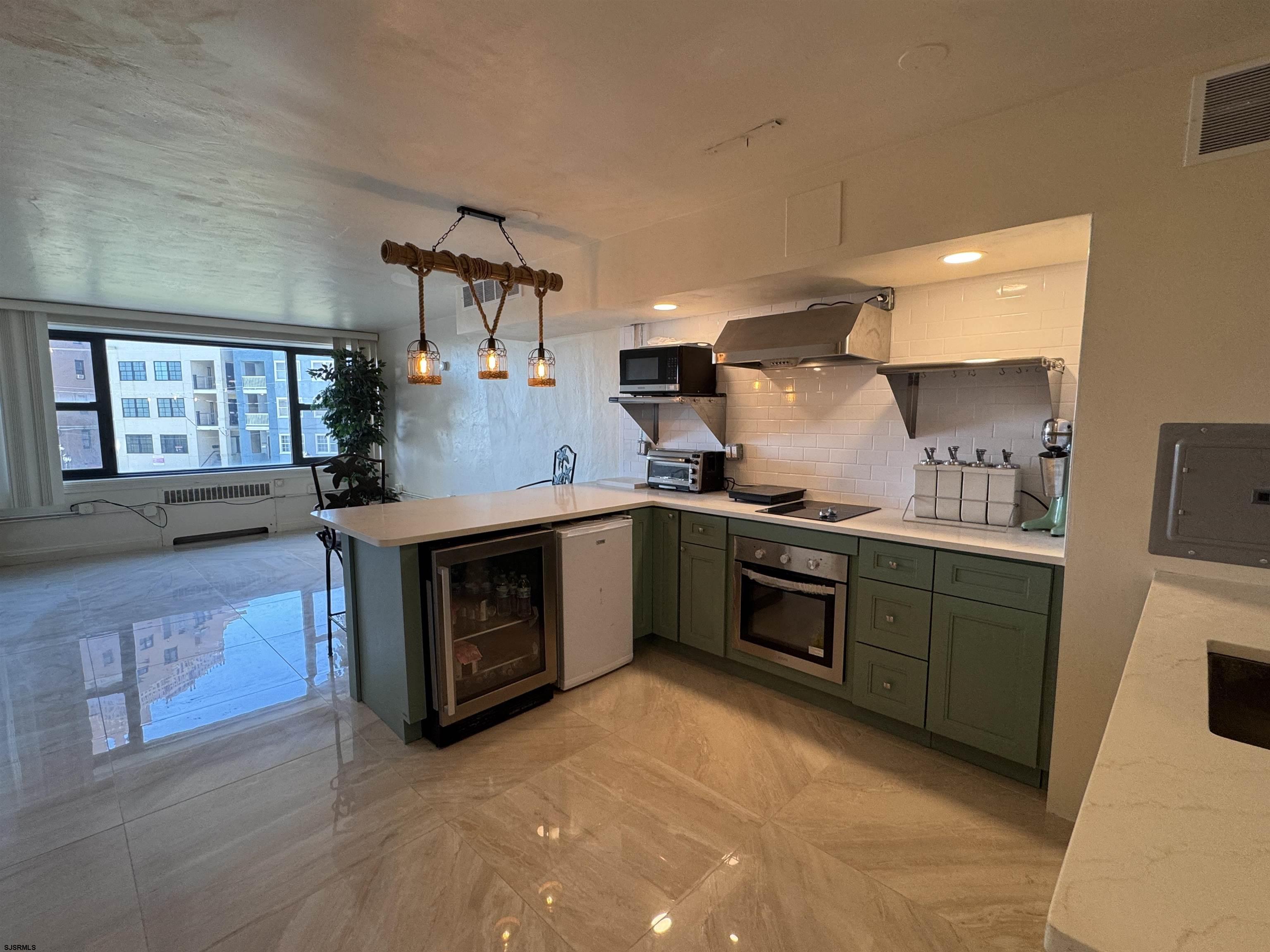 101 South Raleigh Avenue, Unit 210 Atlantic City, NJ 08401 - Photo 3 of 24 a kitchen with stainless steel appliances granite countertop a stove a sink and a refrigerator