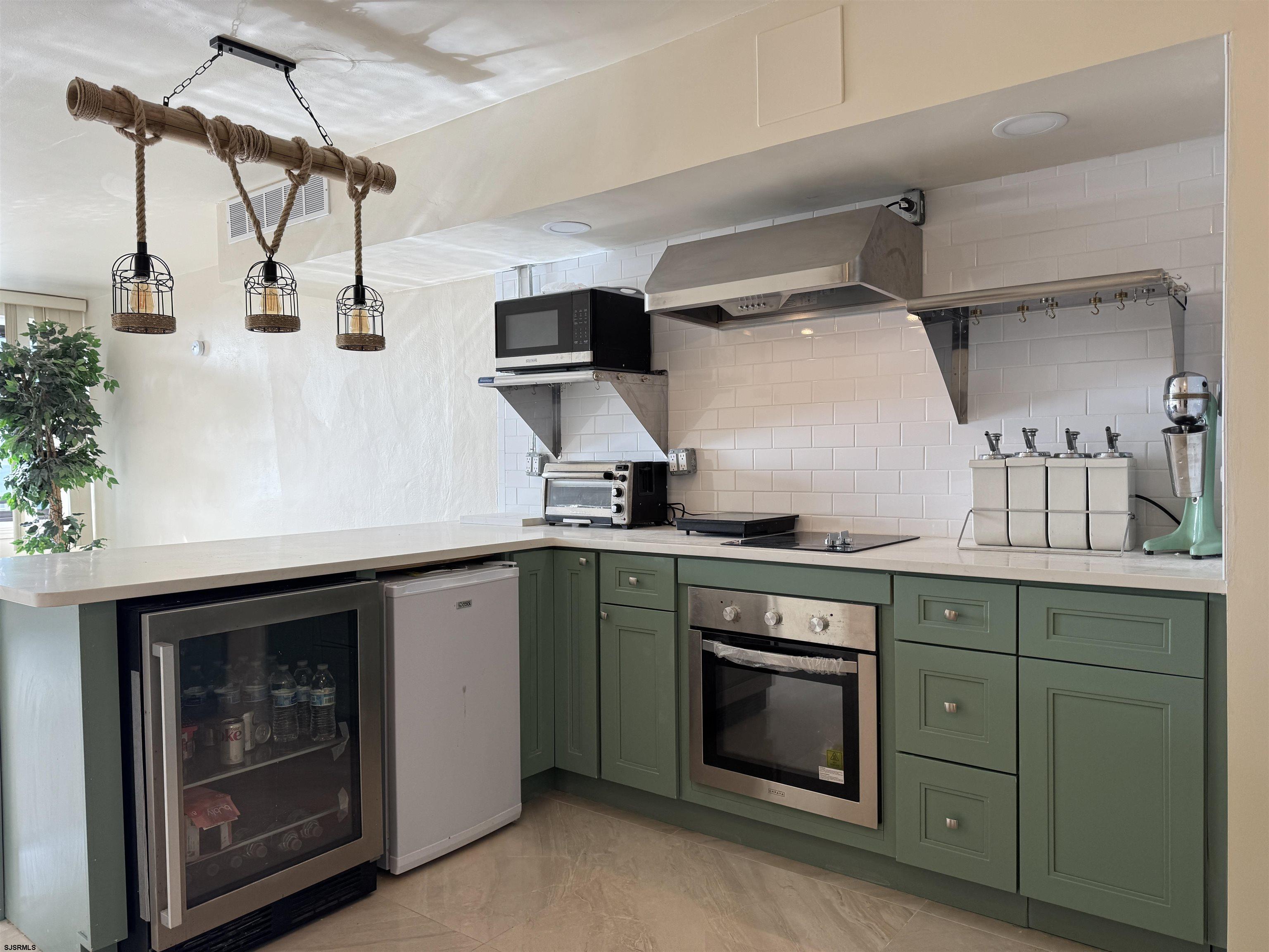 101 South Raleigh Avenue, Unit 210 Atlantic City, NJ 08401 - Photo 4 of 24 a kitchen with stainless steel appliances granite countertop a stove and a sink