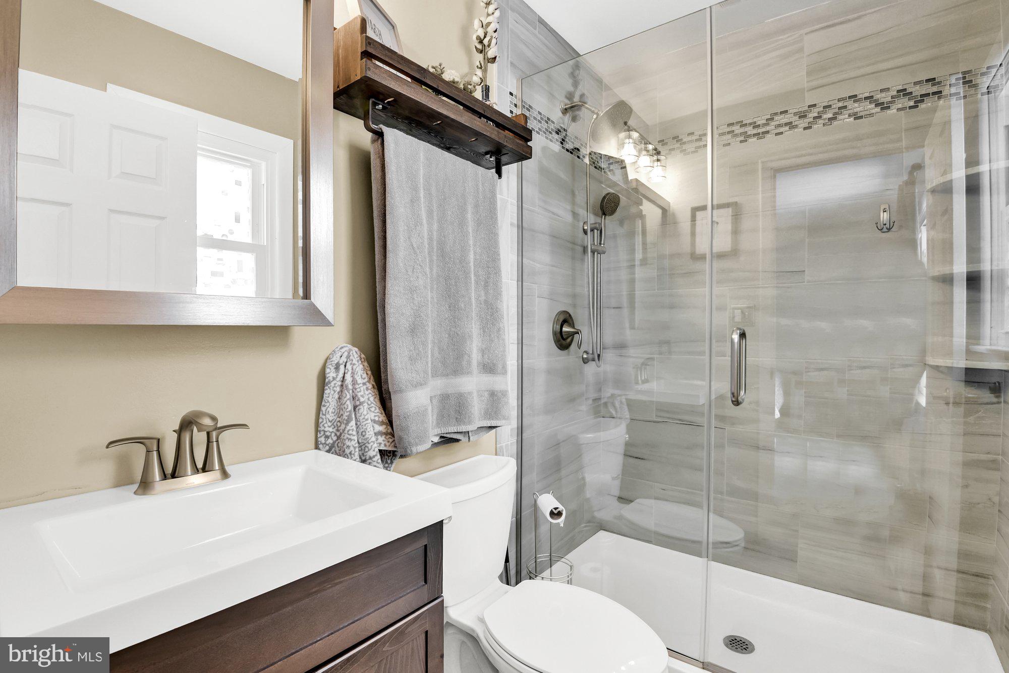 806 Uniontown Road Westminster, MD 21158 - Photo 7 of 10 a bathroom with a sink a toilet and shower