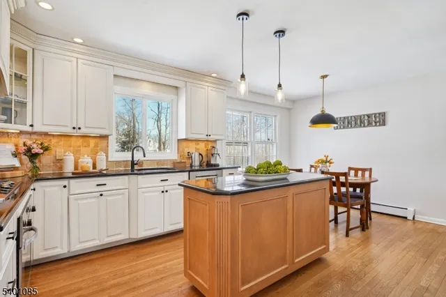 a dining room filled chandelier and wooden floor