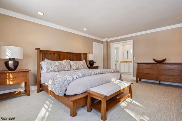 a large bed sitting in a bedroom next to a window and a lamp