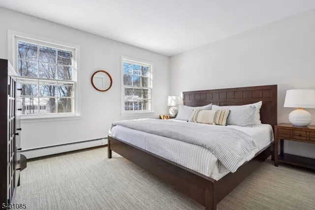 a view of a white house with a snow in a yard