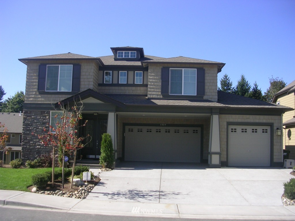 203 Ilwaco Place Southeast Renton, WA 98059 - Photo 1 of 1 a front view of a house with a yard