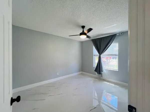 a view of room with window and ceiling fan
