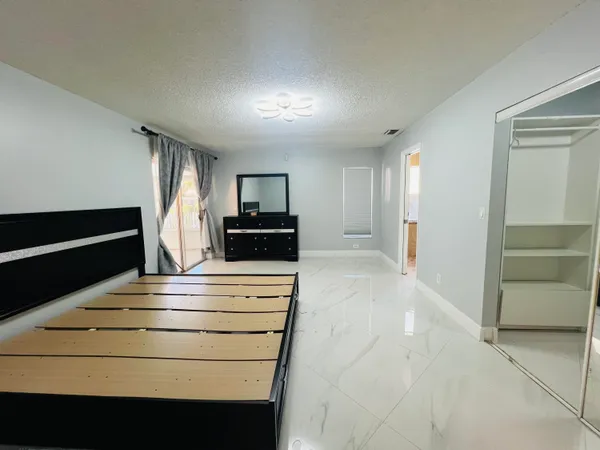 a view of kitchen with cabinets and refrigerator